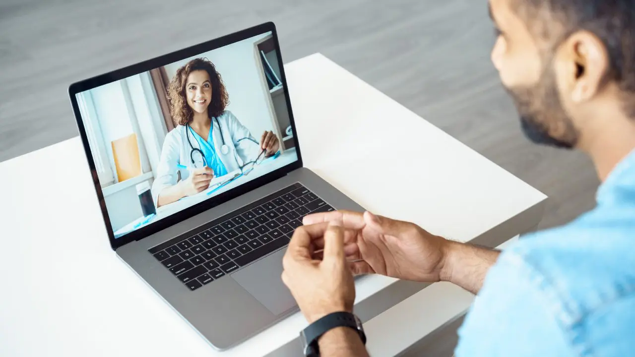 Man having video call with female doctor.