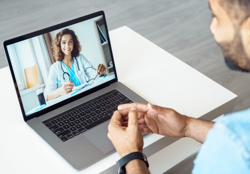 Man having video call with female doctor.